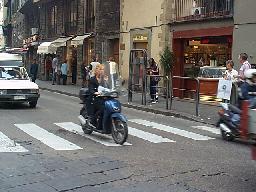 One of the many stylish people on motorbikes. This lady just stepped off the set of Matrix II.