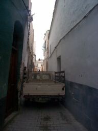 Squeezing a truck through the narrow walls.  You can see marks where other drivers didn't quite make it.