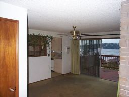 Looking across the dining room, into the kitchen and across the deck.  Check out the security gate on the sliding glass doors.