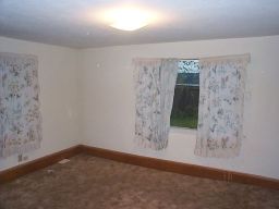 The downstairs bedroom (now my office).  Carpet, baseboard, curtains--mmm.