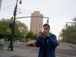 Chris with his camera in front of the Brooklyn Bridge.